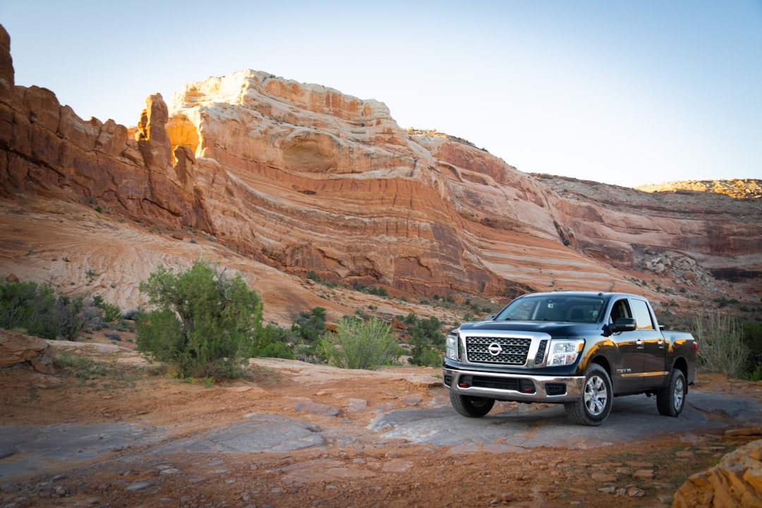 Black 4x4 truck parked in front of a mountain range