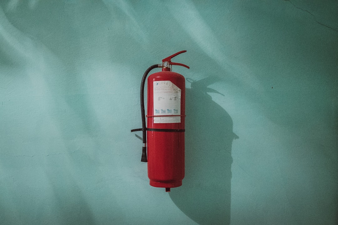 Red fire extinguisher mounted and ready for use in a vehicle